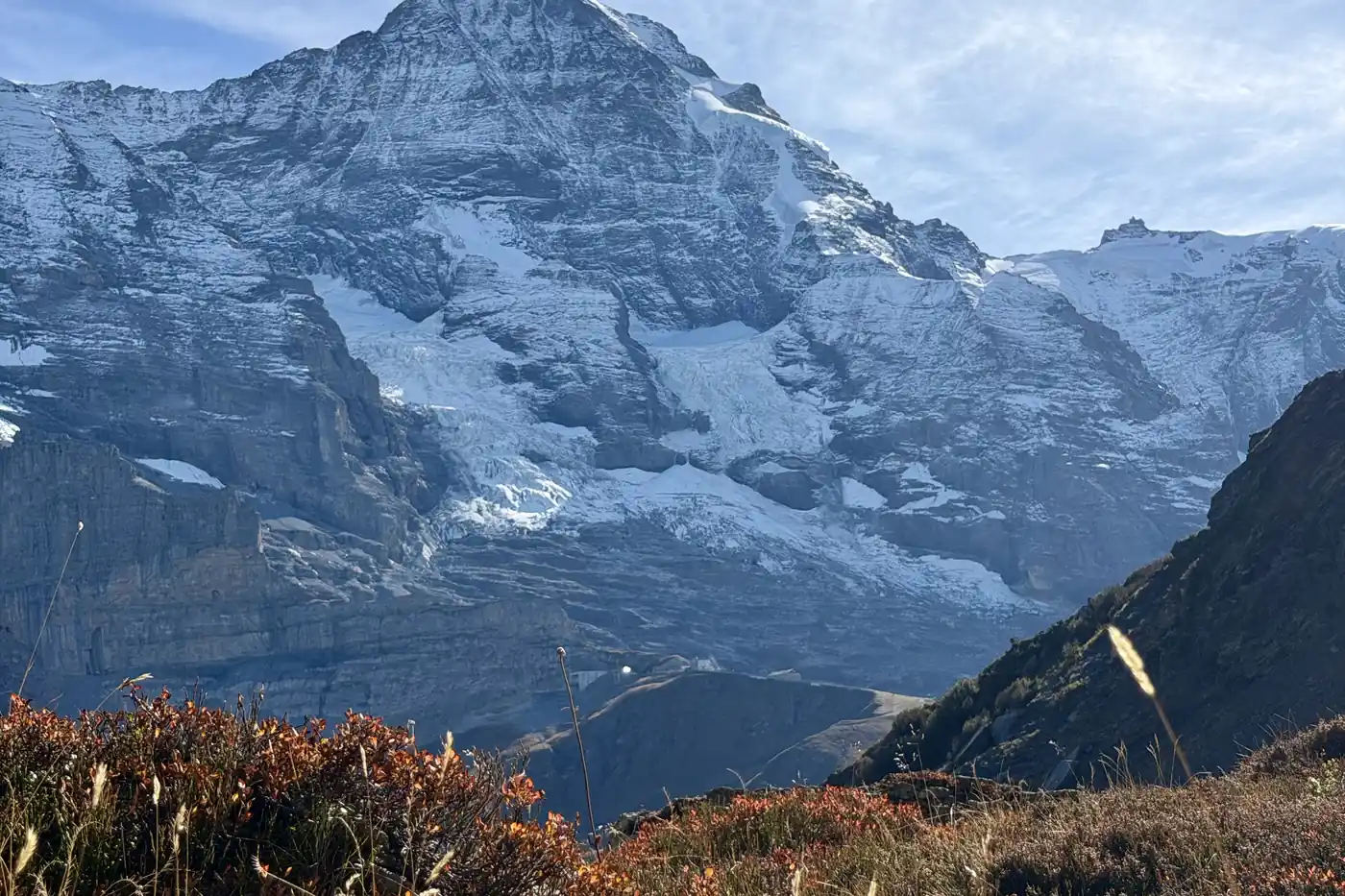 Glacier and snow above red autumn scrub on the high ground above the Lauterbrunnen valley