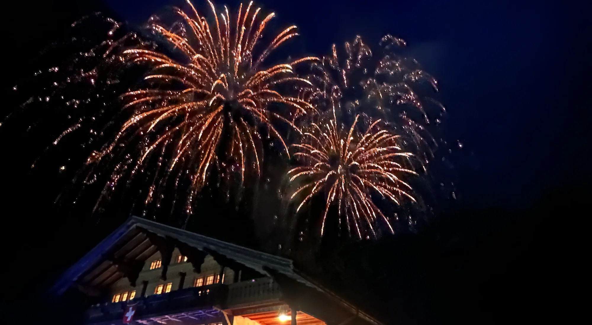 Swiss National Day fireworks over an illuminated chalet in the Lauterbrunnen valley on 1 August